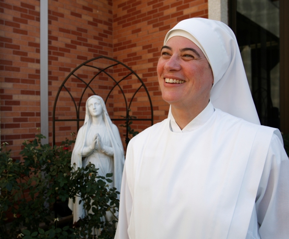 Sister Marie on the grounds Oct. 21, 2009, with a statue of the Virgin Mary in the background. Sister Marie Sophie, a nun at Little Sisters of the Poor, just took a group to Rome for the canonization of the order's founder, Jeanne Jugan. (Press-Register, Mary Hattler) religion, Sister Marie Sophie